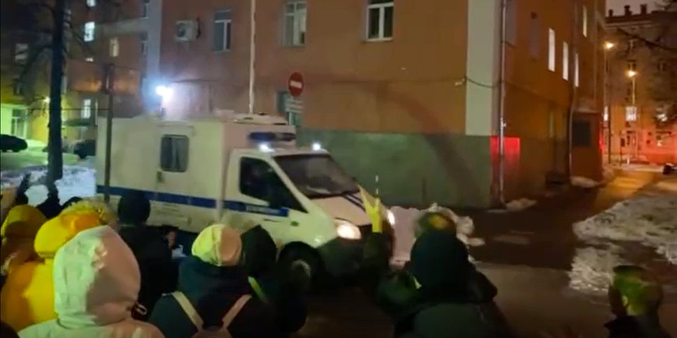 Convicted persons are taken away in a police van after sentencing